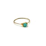 Handmade Solstice Ring with wrapped gemstone on a slim gold band